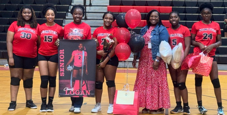 Senior volleyball players from Sumter Central High School pose together on the gym floor during Senior Night.