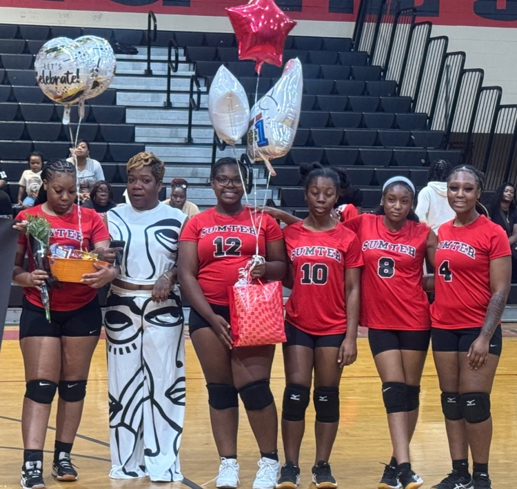Senior volleyball players from Sumter Central High School pose together on the gym floor during Senior Night.