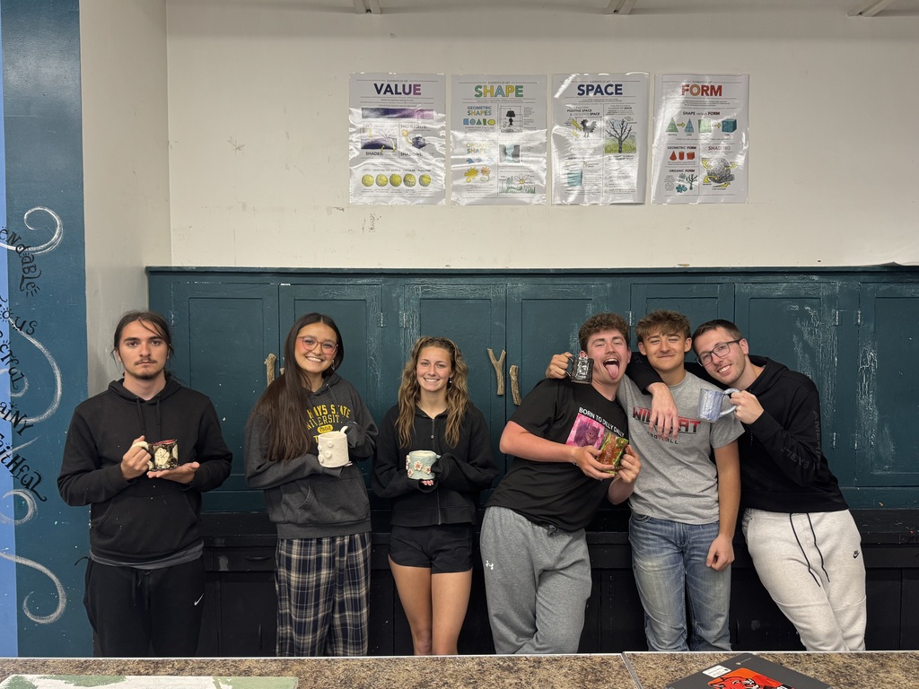 Seniors showing off their Ceramic Mugs