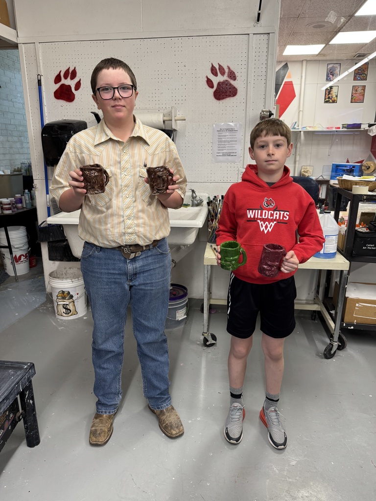 6th Graders showing off their Ceramic Mugs