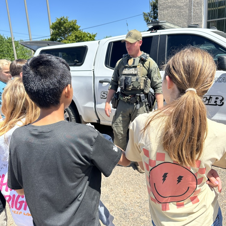 Students asking questions about caring for drug dogs. 