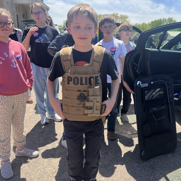 A student wearing an officer’s protective vest