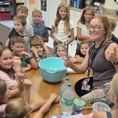 Student and teacher sitting a table mixing up Jitter Juice!