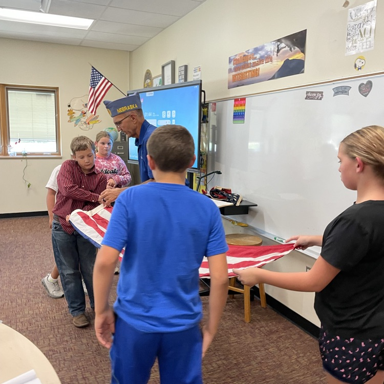 5th graders folding the flag. 