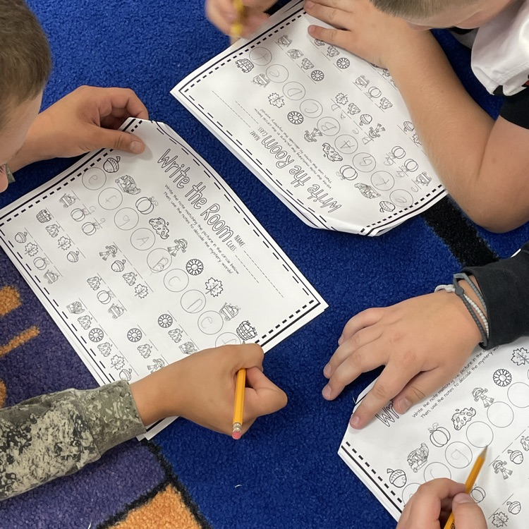 Fifth grade boys working together to decode secret words.