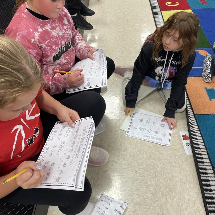 Fifth grade girls working as a team to uncover their secret words.