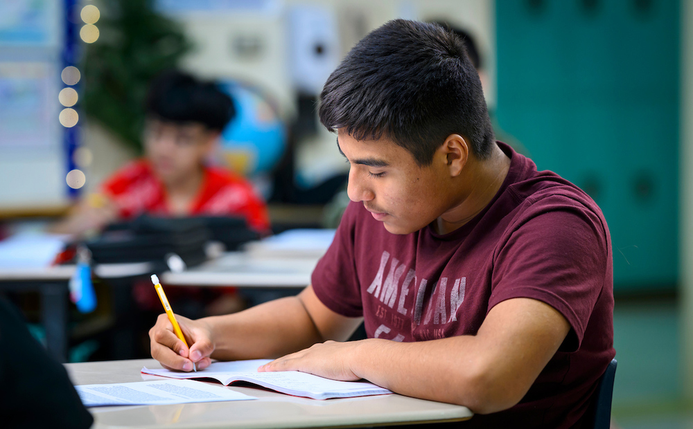 Student at CMS writing in notebook