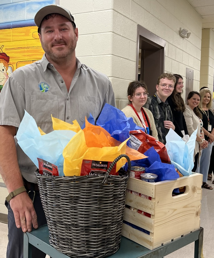 Theo receiving a gift basket from the staff