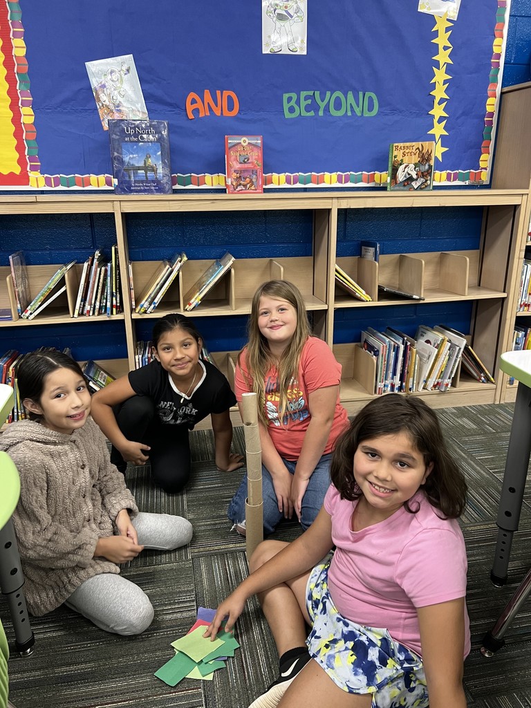 students making a "beanstalk" from toilet paper rolls