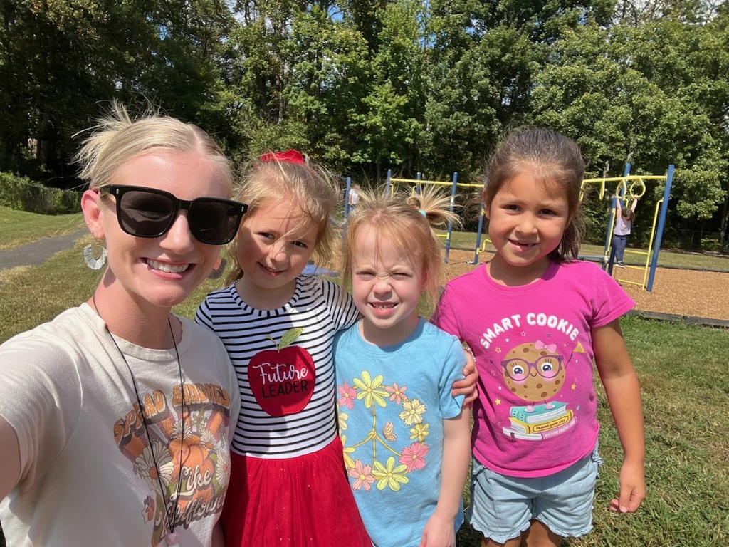 students and teacher smiling