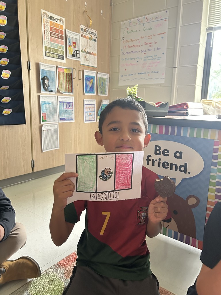 student showing the flag they colored