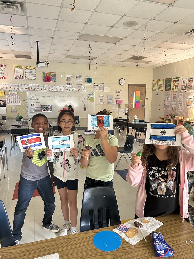 students showing the flags they colored