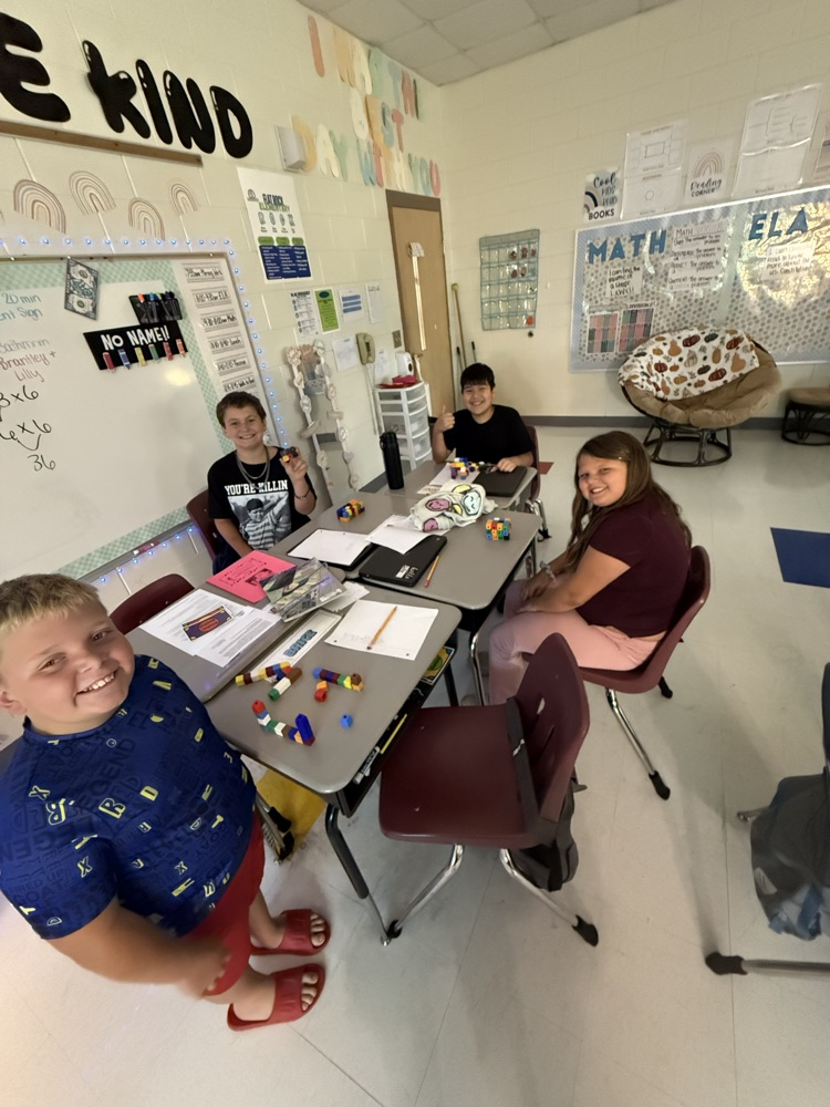 students using blocks to find the volume of a figure