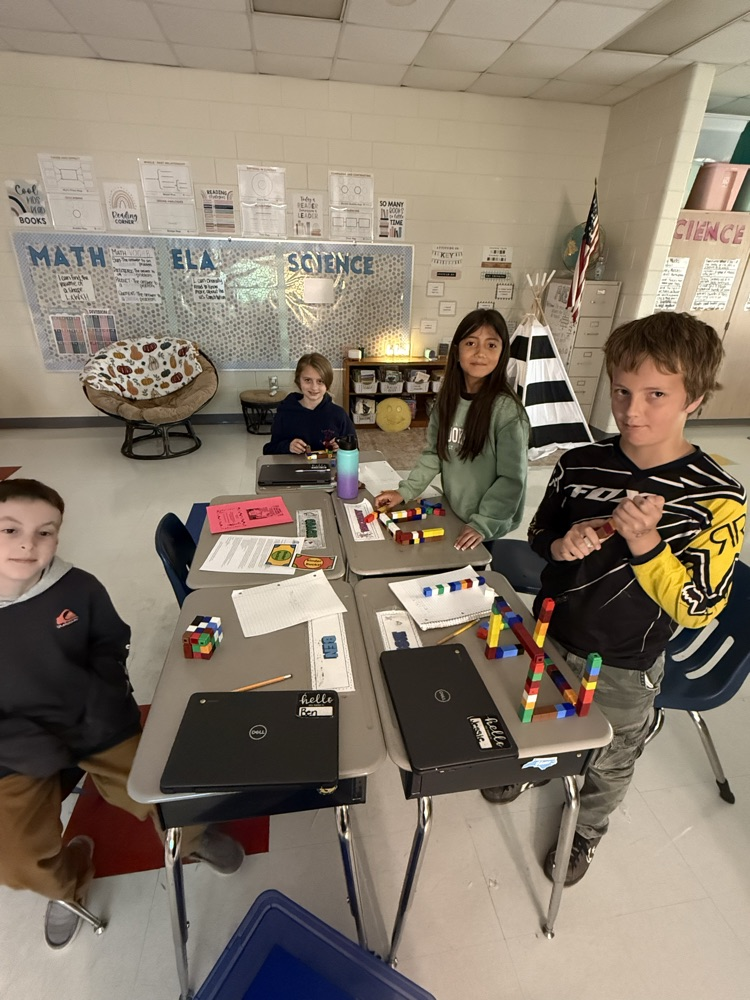 students using blocks to find the volume of a figure