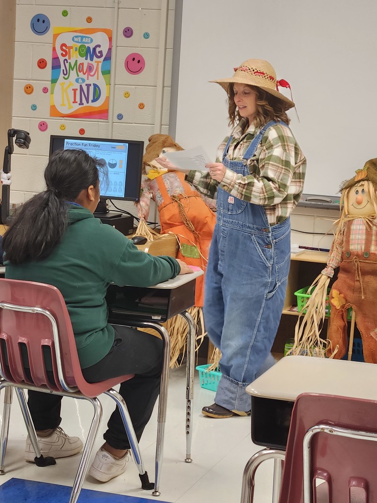 Mrs. Edwards dressed as a farmer reading poetry to third grade