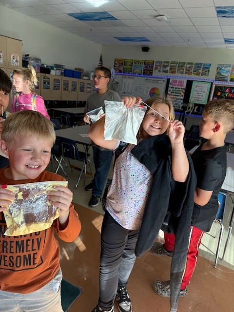 The Science Club was brewing during their October meeting. They made glow in the dark slime while learning about polymers!