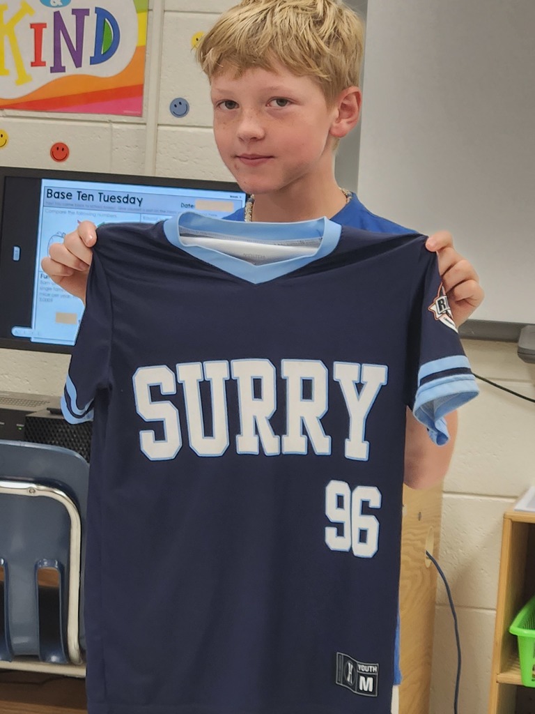 student showing the item they brought to class