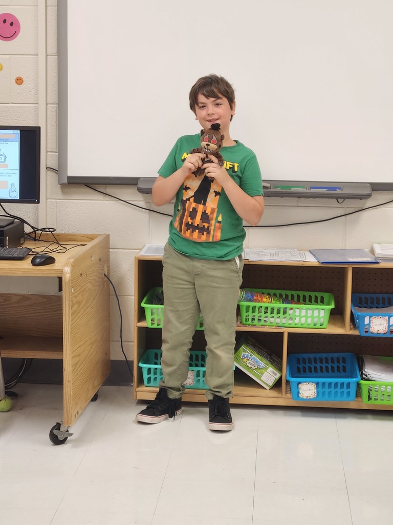 student showing the item they brought to class