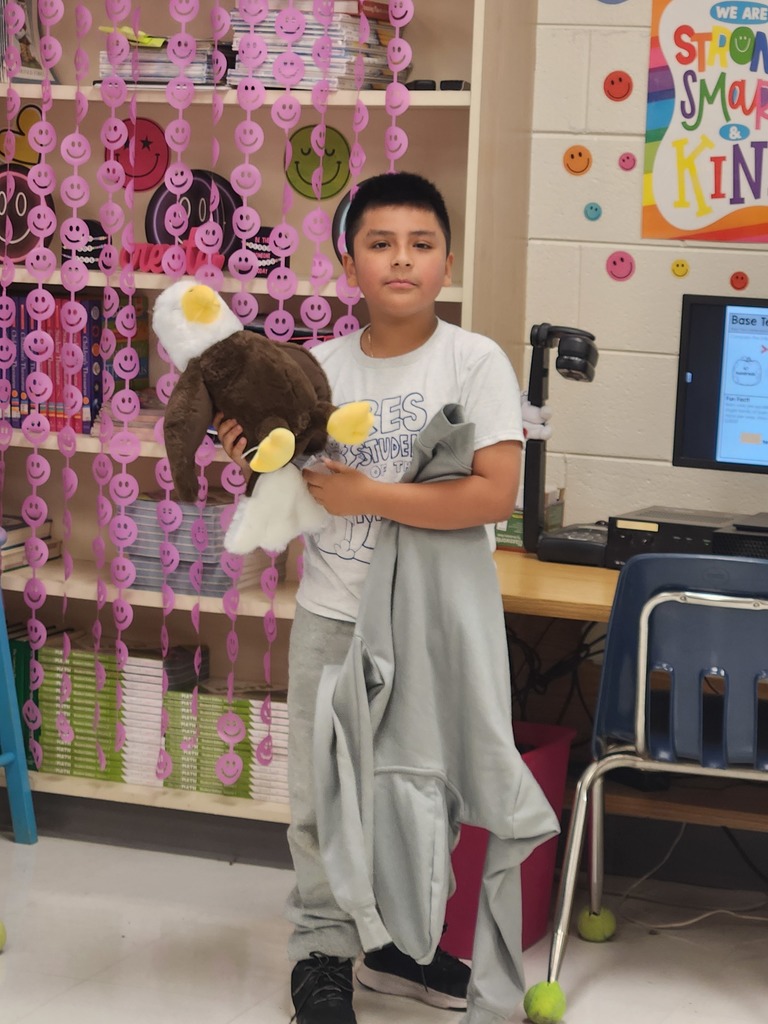 student showing the item they brought to class