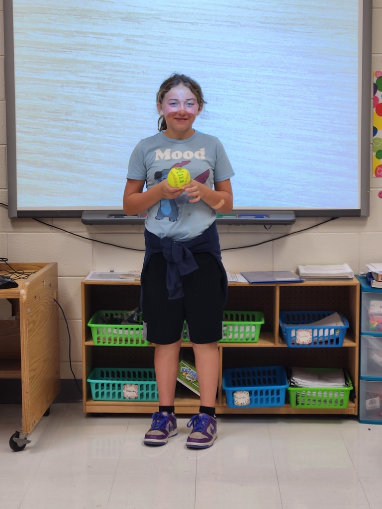 student showing the item they brought to class