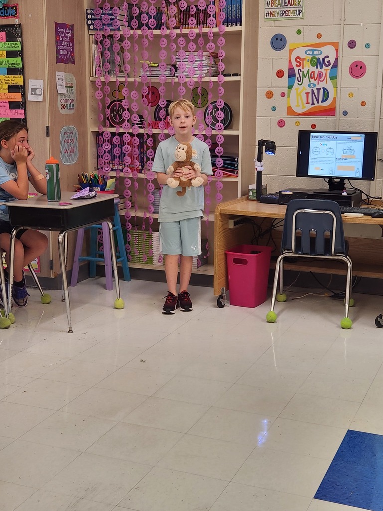 student showing the item they brought to class