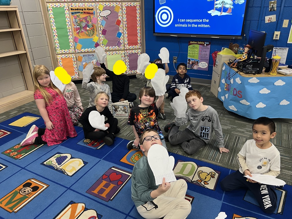 students posing with the mittens they made