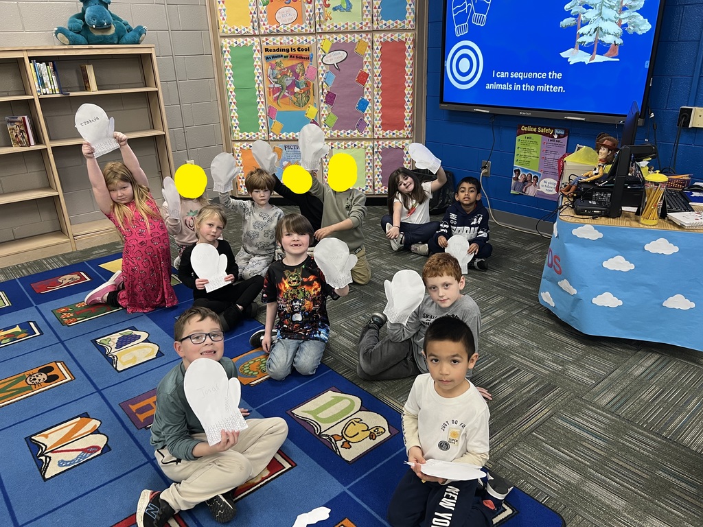 students posing with the mittens they made