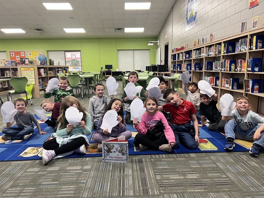 students holding the mitten they created