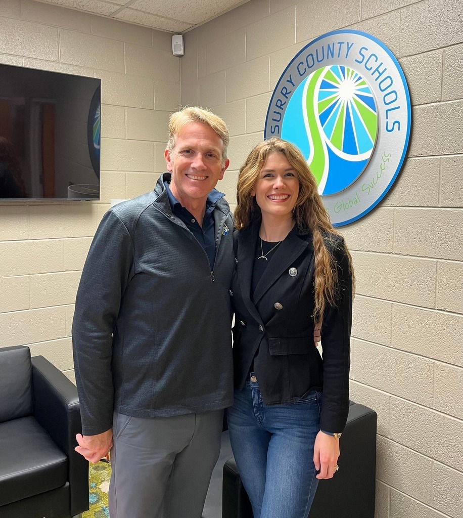 Dr. Reeves and Weatherly Reeves pose with the SCS logo