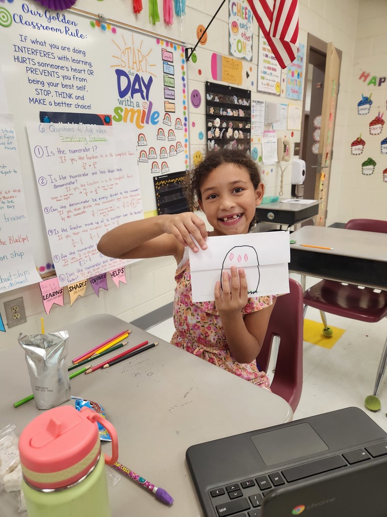 student showing off their Easter Bunny drawing