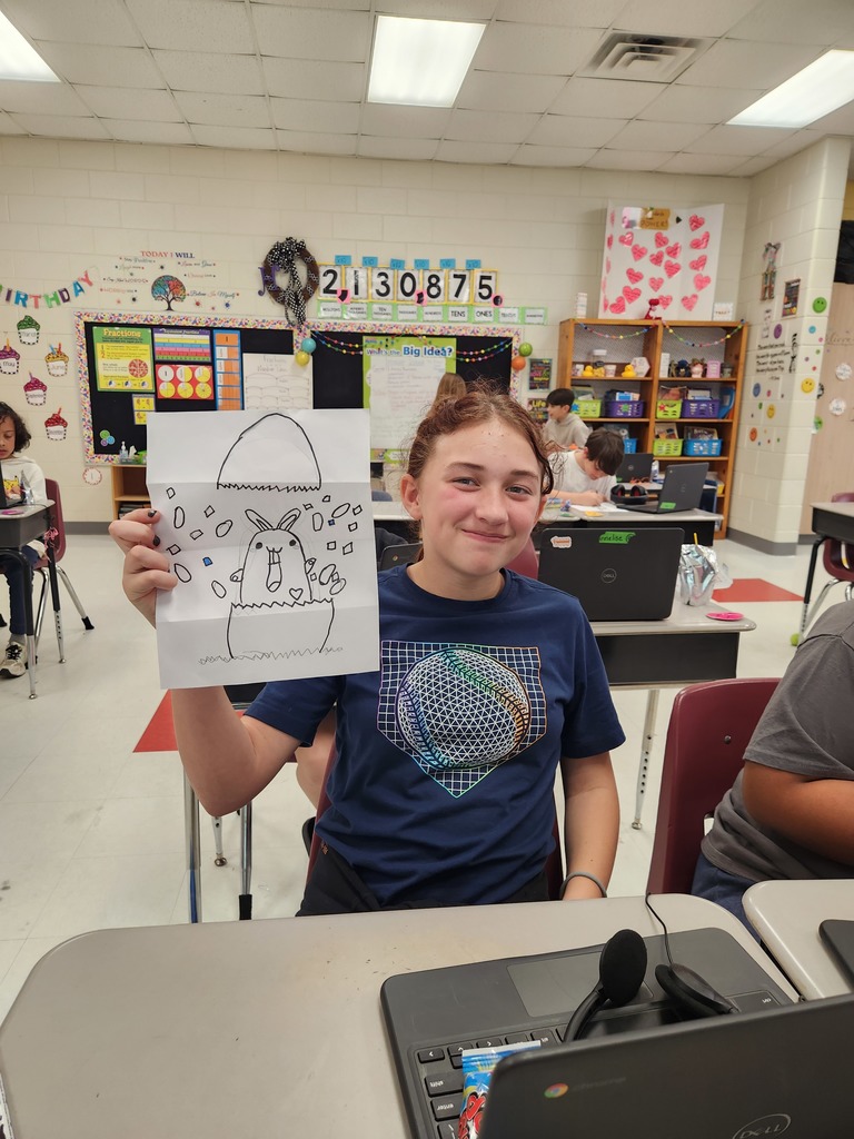 student showing off their Easter Bunny drawing