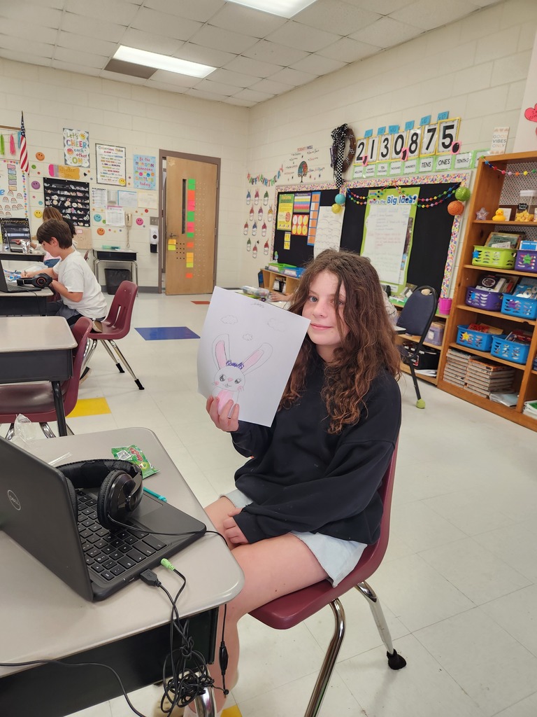 student showing off their Easter Bunny drawing