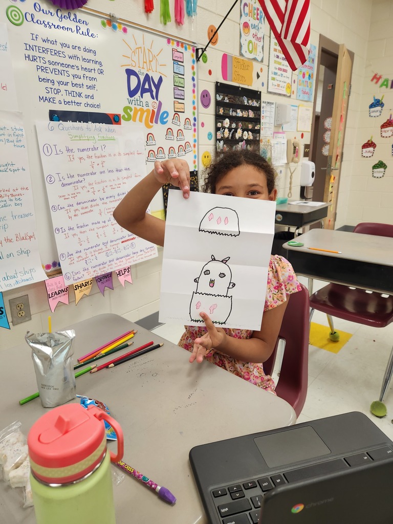 student showing off their Easter Bunny drawing