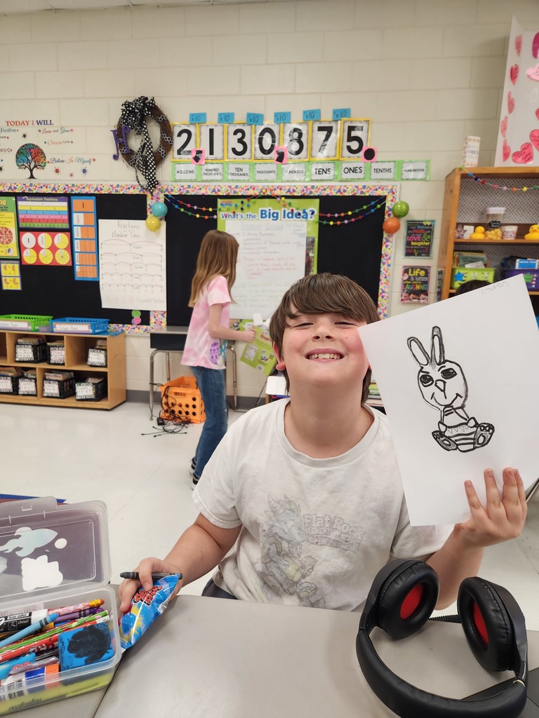 student showing off their Easter Bunny drawing