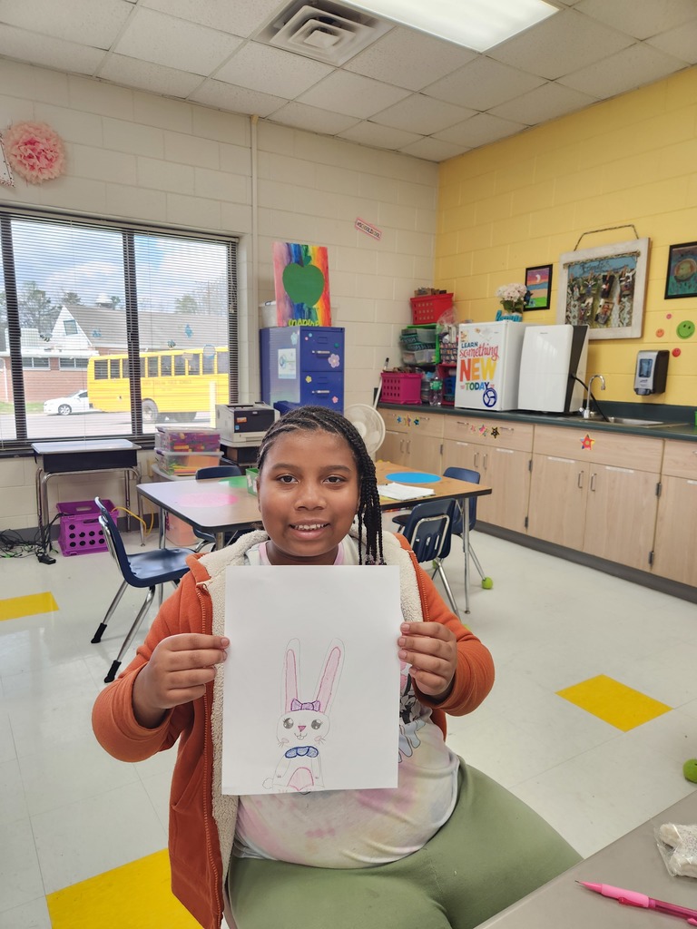 student showing off their Easter Bunny drawing
