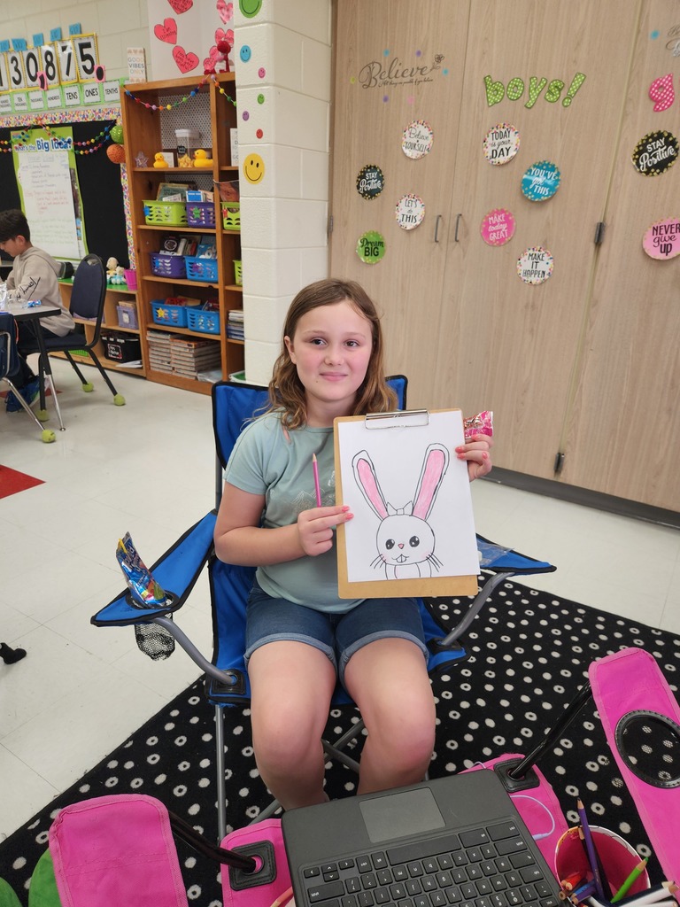 student showing off their Easter Bunny drawing