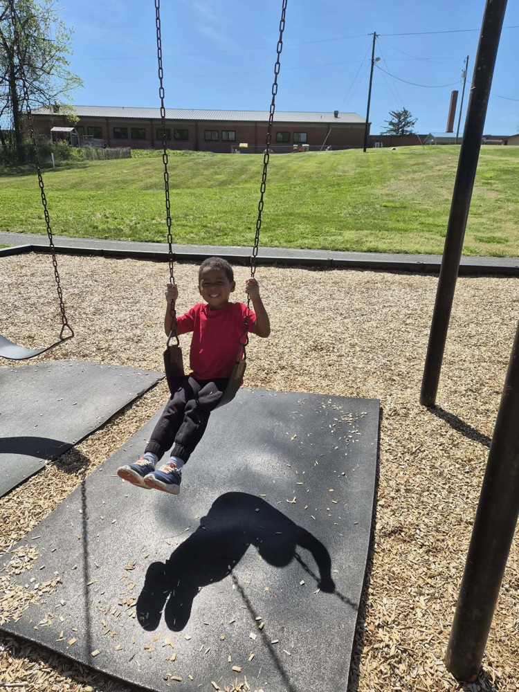pre k students playing on the big kid playground