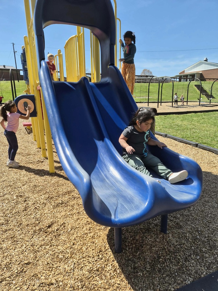 pre k students playing on the big kid playground