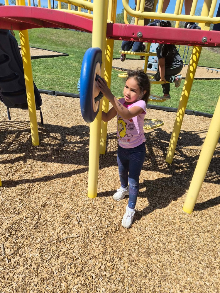 pre k students playing on the big kid playground