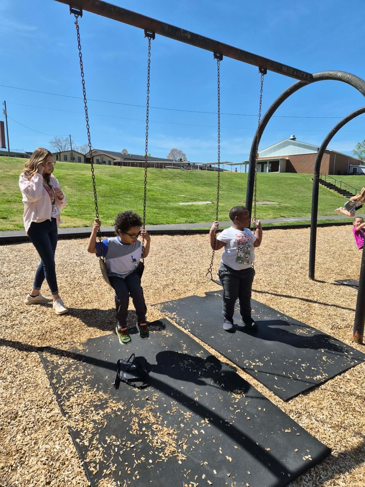 pre k students playing on the big kid playground