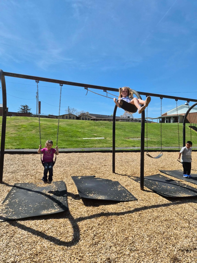 pre k students playing on the big kid playground