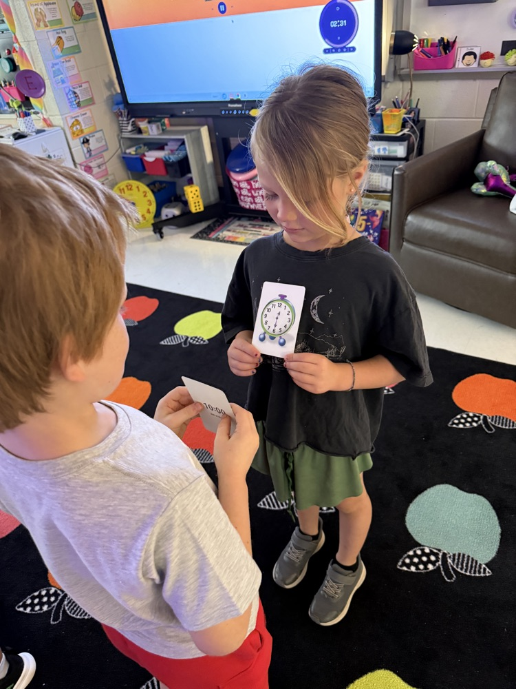 students practicing telling time