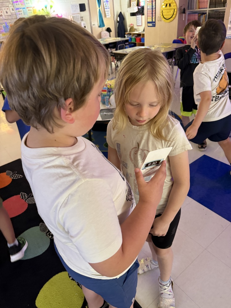 students practicing telling time