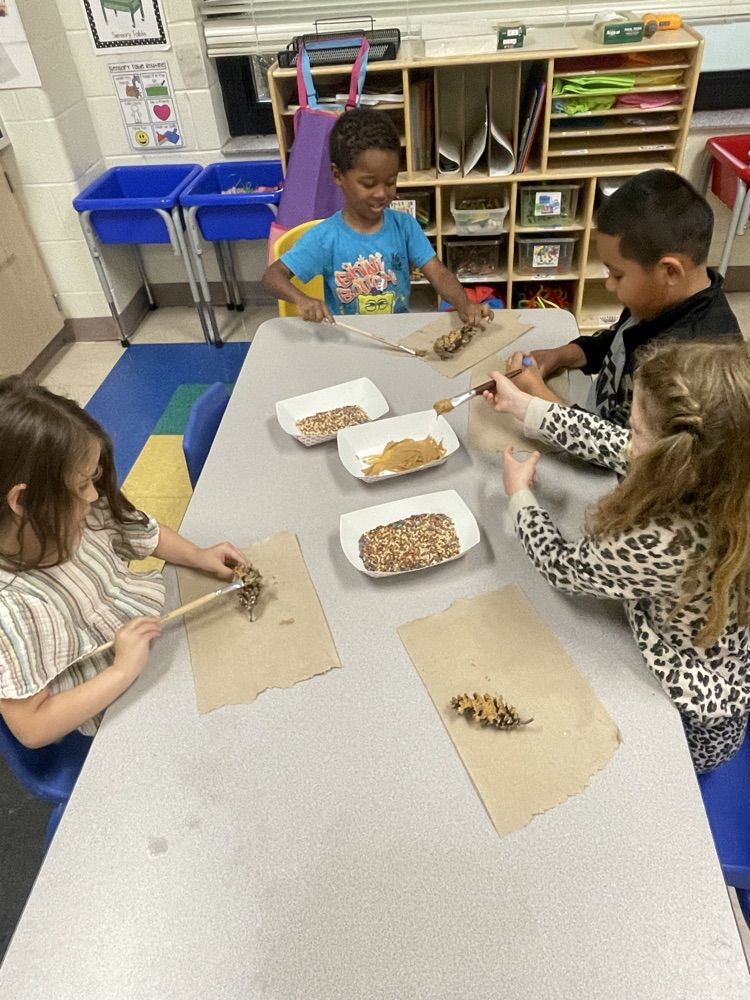 students making bird feeders