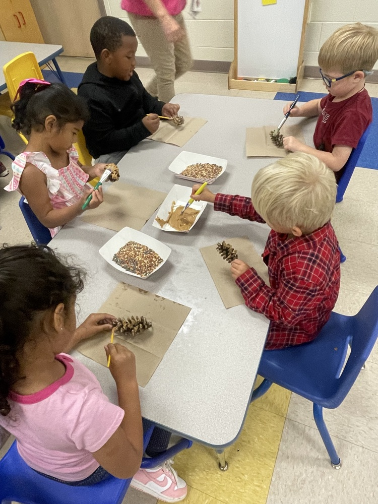 students making bird feeders