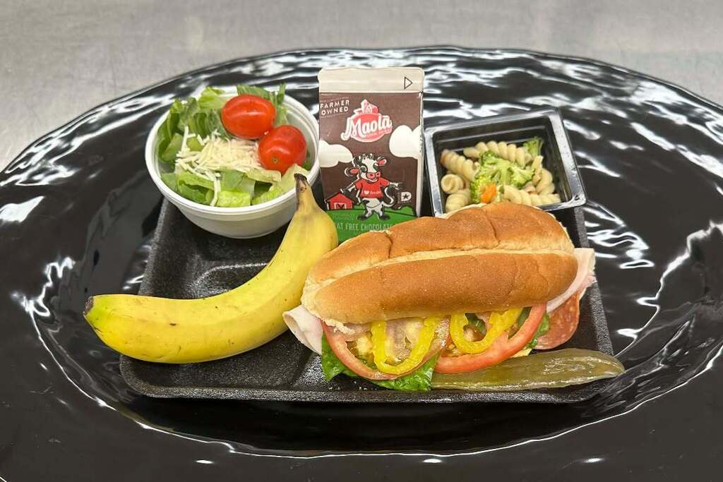 lunch plate at GMS with sandwich, banana, pasta salad, and salad