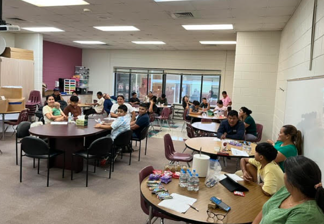 Big group shot of students and their family at the first meeting of the year