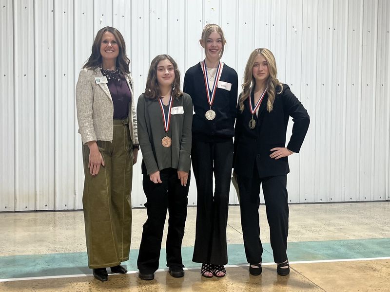Original Oratory Photo (l-r): Dr. Shelley Goins, Director of Secondary Curriculum and Accountability, Emily Felcyn, Allison Stephens, and Emma Edwards.