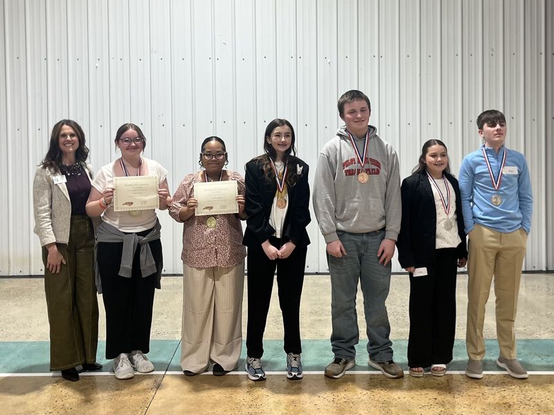 Public Forum Photo (l-r): Dr. Shelley Goins, Director of Secondary Curriculum and Accountability, Noelle Childers, Jasmine Snow, Sarah Boaz, Don Howard, Scarlett Lowman, and Caden Hill.