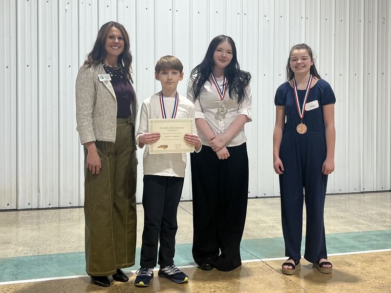 Humorous Interpretation Photo (l-r): Dr. Shelley Goins, Director of Secondary Curriculum and Accountability, Liam Mitchell, Hailey Burch, and Madison Snow.
